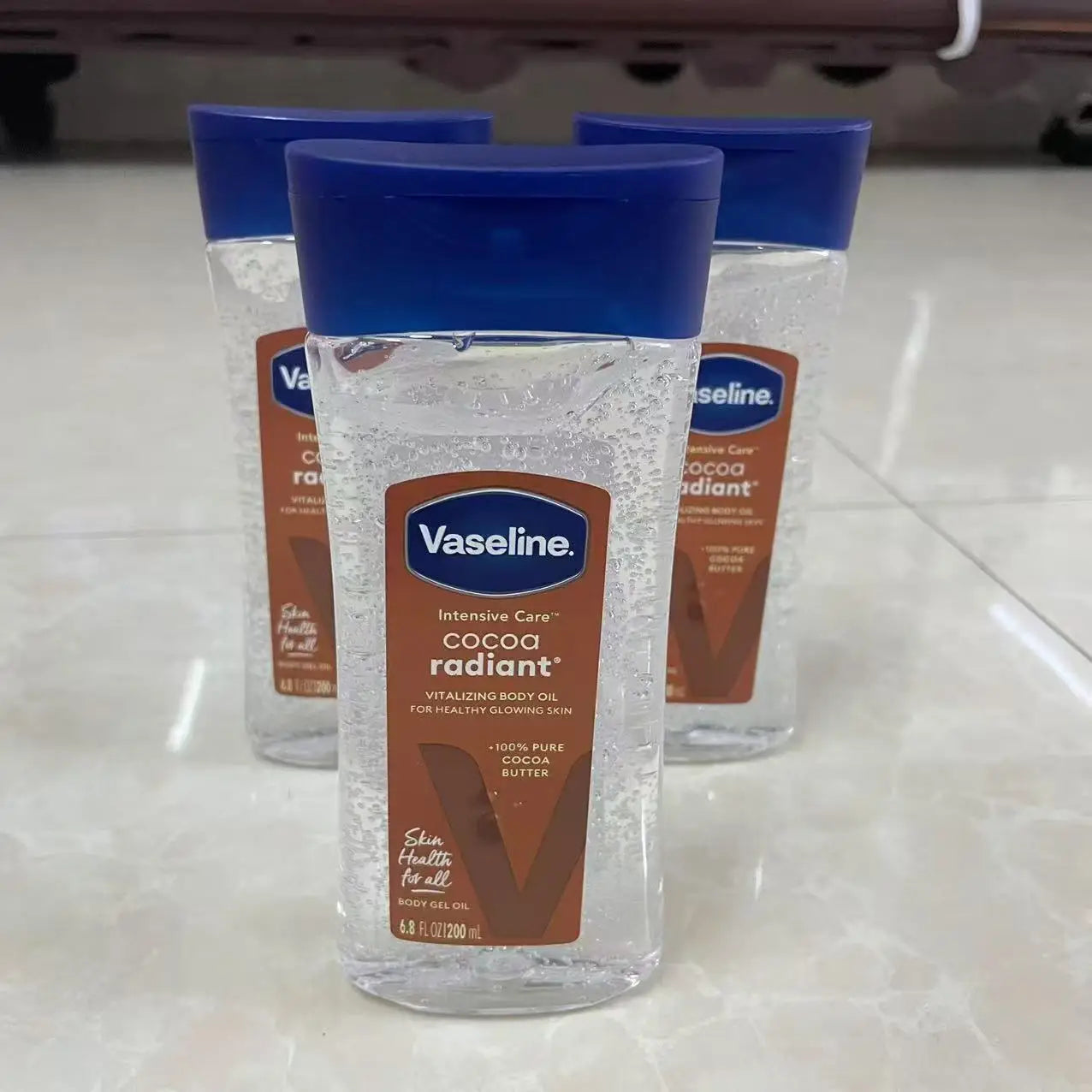 Vaseline cacao huile lumineuse pour le corps 200ml huile de soin hydratante longue durée pour la peau corps éclaircissant Anti-séchage Essence produit de soin